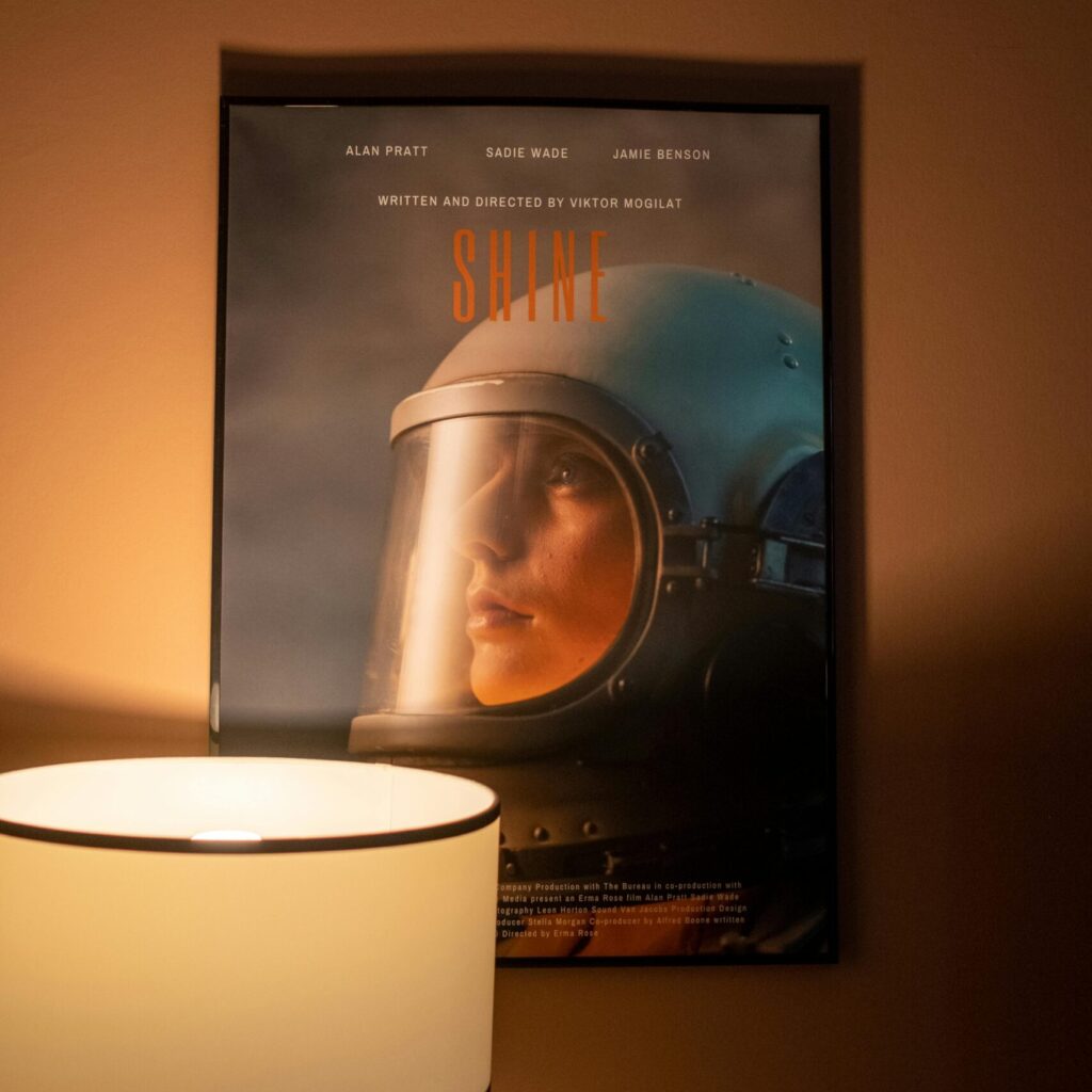 Warm home interior featuring an astronaut poster beside a stylish lamp.